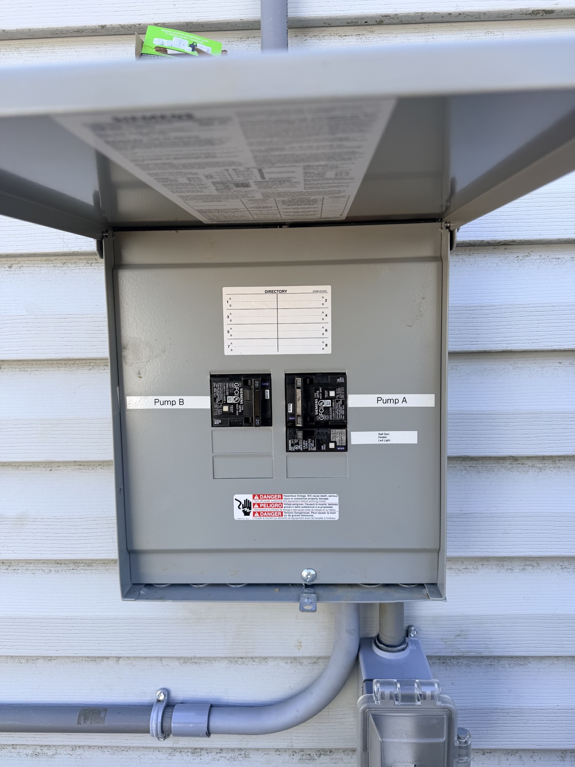 Outdoor pool equipment panel with GFCI-protected pump circuits installed by Scherner Electric
